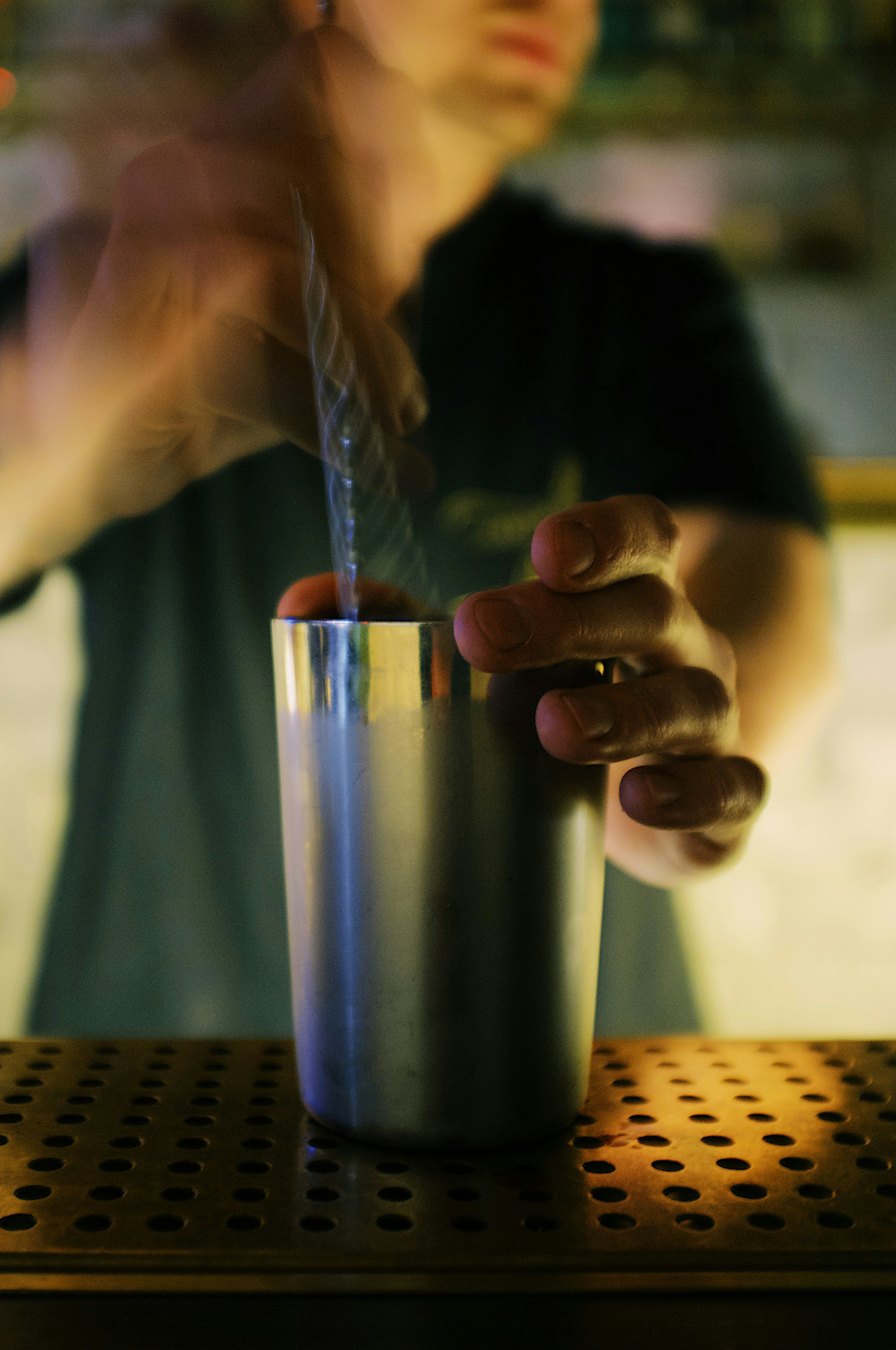 person holding stainless steel cup